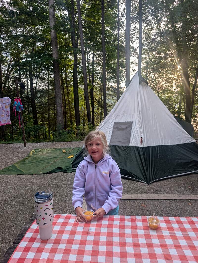 Eve at the camp in front of the tent