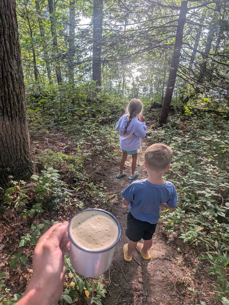 Walking down to the lake from the campsite with coffee in hand